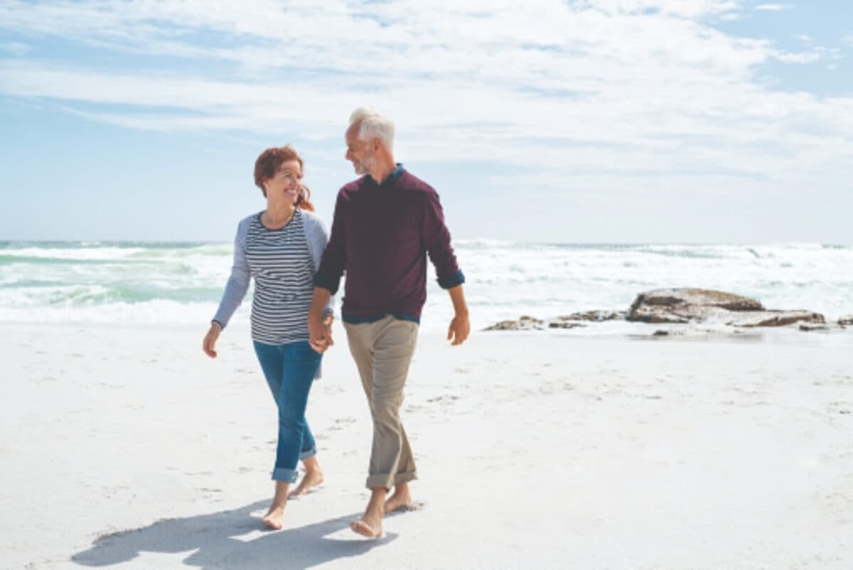 A couple walking together along a beach